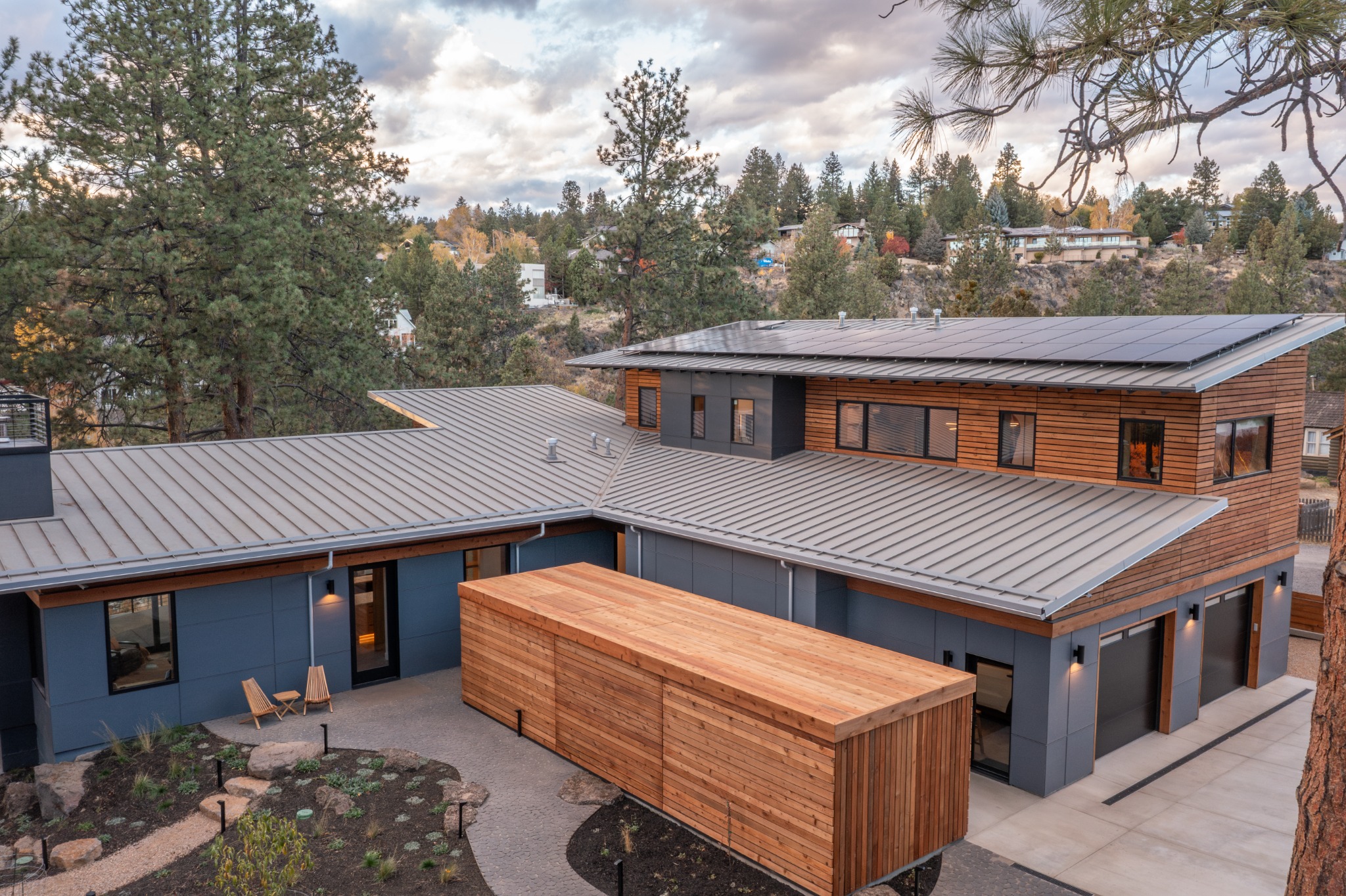 Professional daytime aerial photograph of the cedar siding and outdoor living project